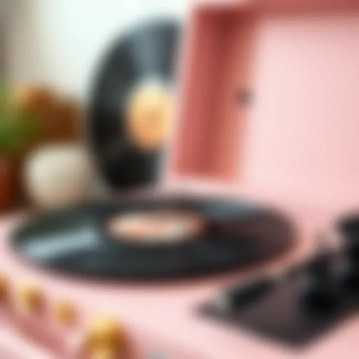 Close-up of light pink record player with vinyl records